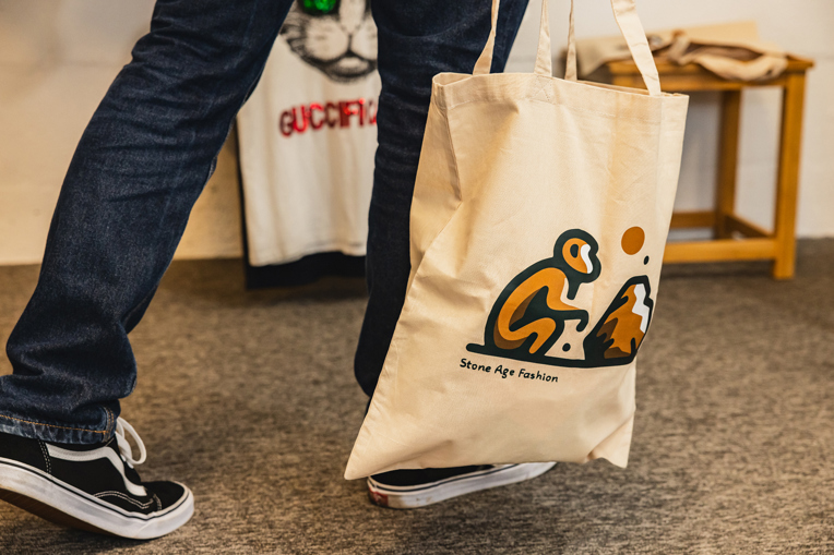 Man carrying Stone Age Fashion tote bag